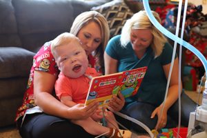 Cayden working with his nurse, Stacy Mahley, LPN and his occupational therapy assistant, Lindsay Martin, OTA