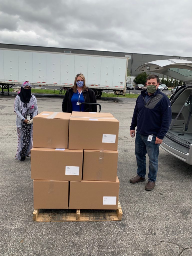 Pictured with boxes of shields: Farhiyo Alasow and Darrell Finck of Alene Candles (ends), Tabitha Butcher, Marion County Board of DD (center) meet to load up the boxes and bring back to the COG’s PPE Headquarters in Marion