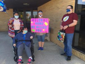 MARCA employees and people served are pictured here welcoming back their adult day service participants. MARCA is also a provider of MCBDD and offers adult day services and community employment opportunities for those served.