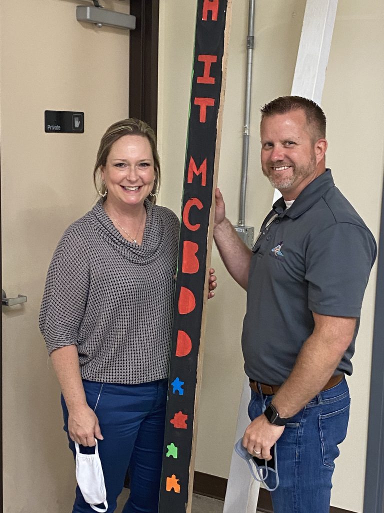 Wings of an Angel, R.I.S.E. Owners, Heidi & Ryan Ballinger pose with a Peace Pole that was designed by attendees of the program