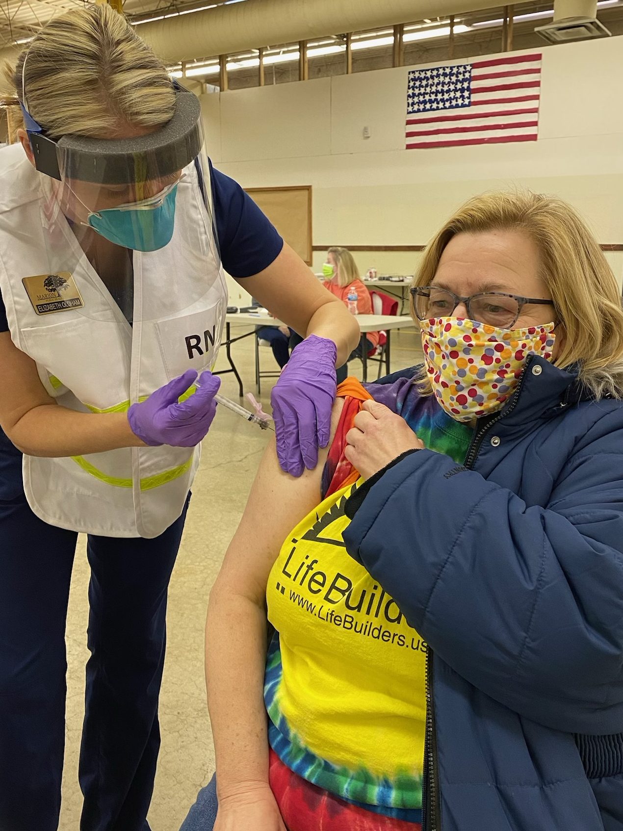 Janet Grossman is a direct support professional (DSP) for Life Builders, an Adult Day Service (ADS) provider. She is pictured here receiving her second COVID vaccination at the MCBDD.