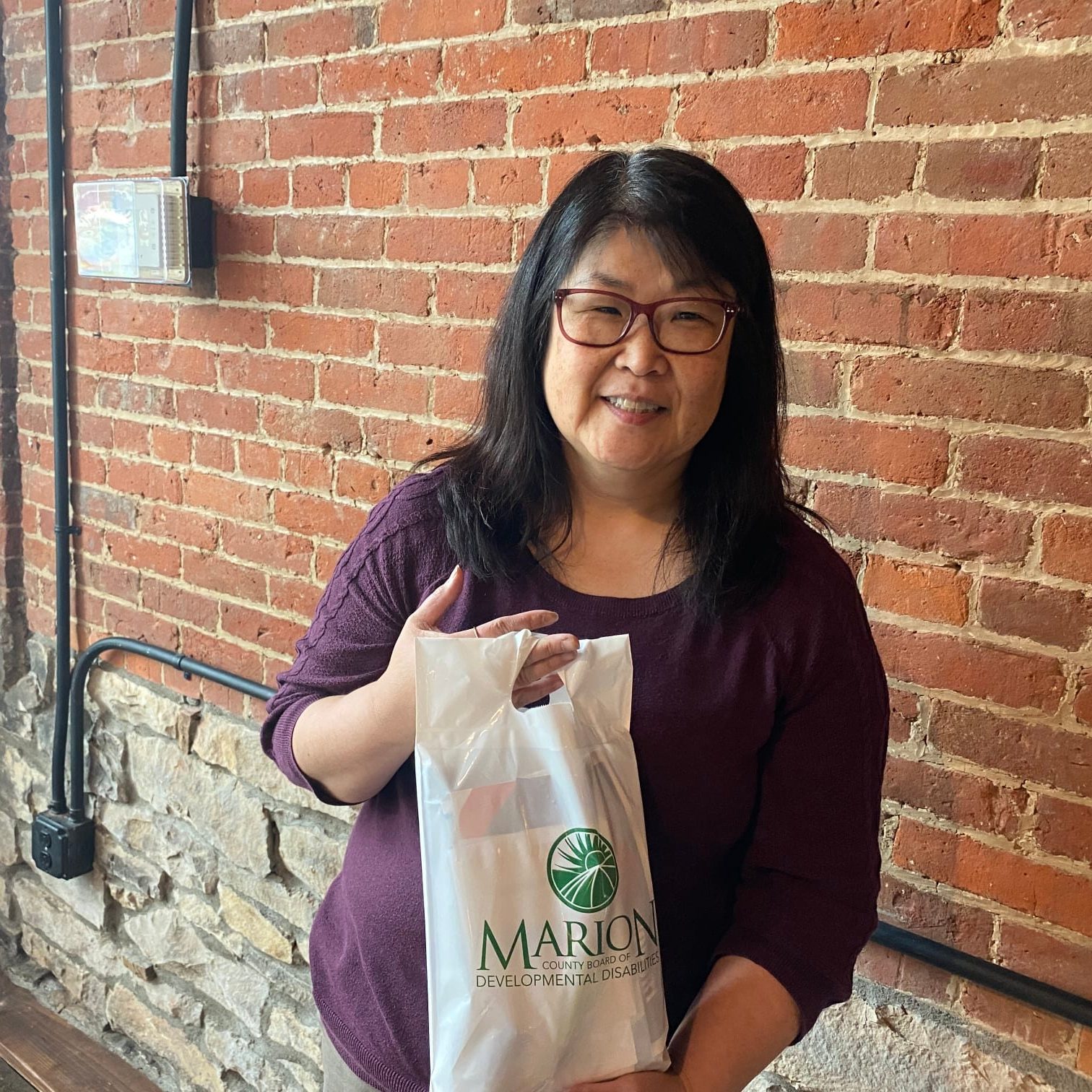 Marsha Cametti works at the Marion County Board of DD and handed out the books that both authors provided to each attendee.