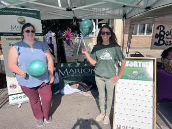 Two Service and Support Administration enjoy the festivities at the Downtown Marion Third Thursday while promoting the work of MCBDD.
